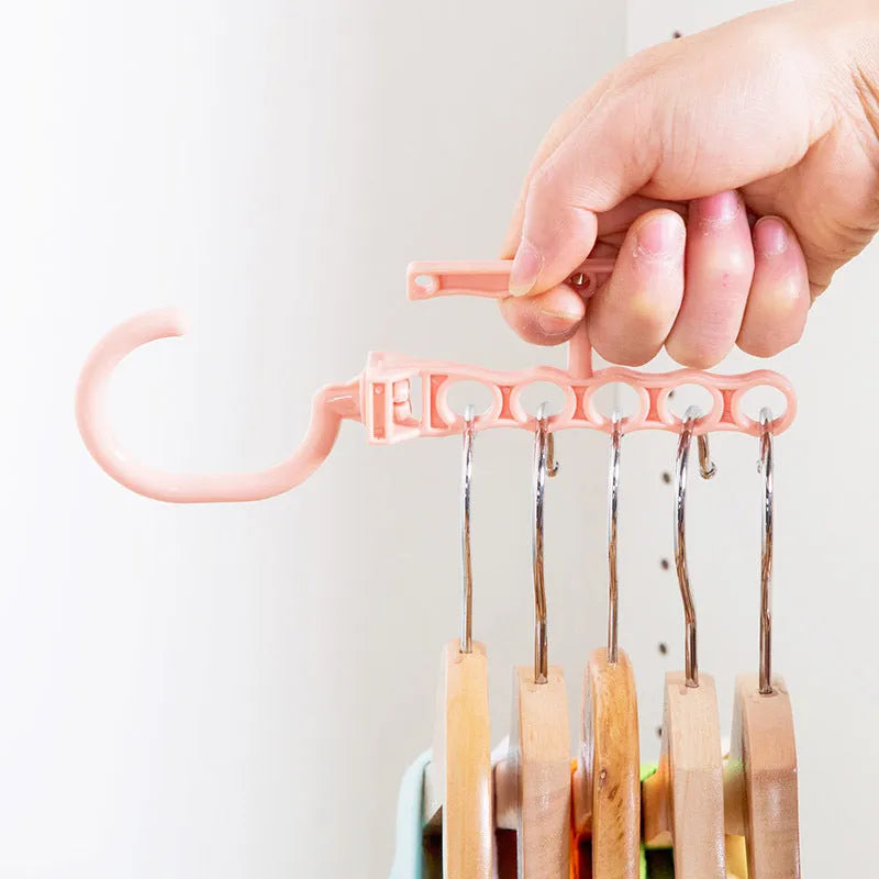 Blue revolving wardrobe hanger with five rotating branches and a top handle