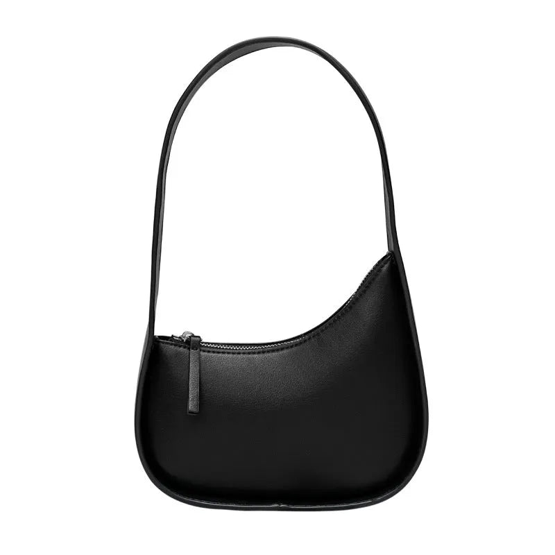 Small half moon shaped women's leather shoulder bag with a wide strap and soft handle.