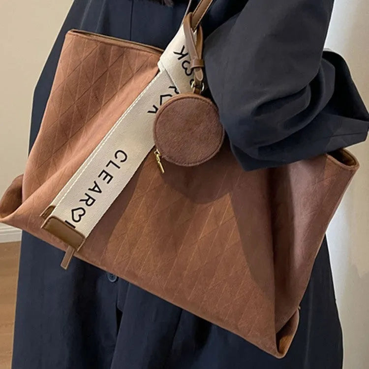 Large capacity polyester shoulder bag in green colour showing horizontal square shape and shoulder strap