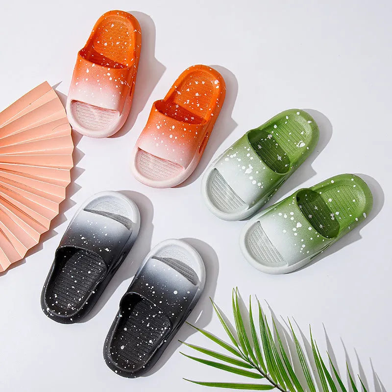 Gradient blue children's PVC summer slippers with a non-slip sole on a wooden deck.