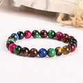 Colourful tiger eye bracelet with round beads in mixed sizes on a woman's wrist