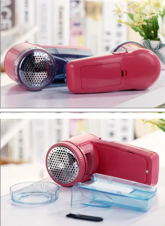 Compact blue portable electric lint remover for clothing on a grey sweater.