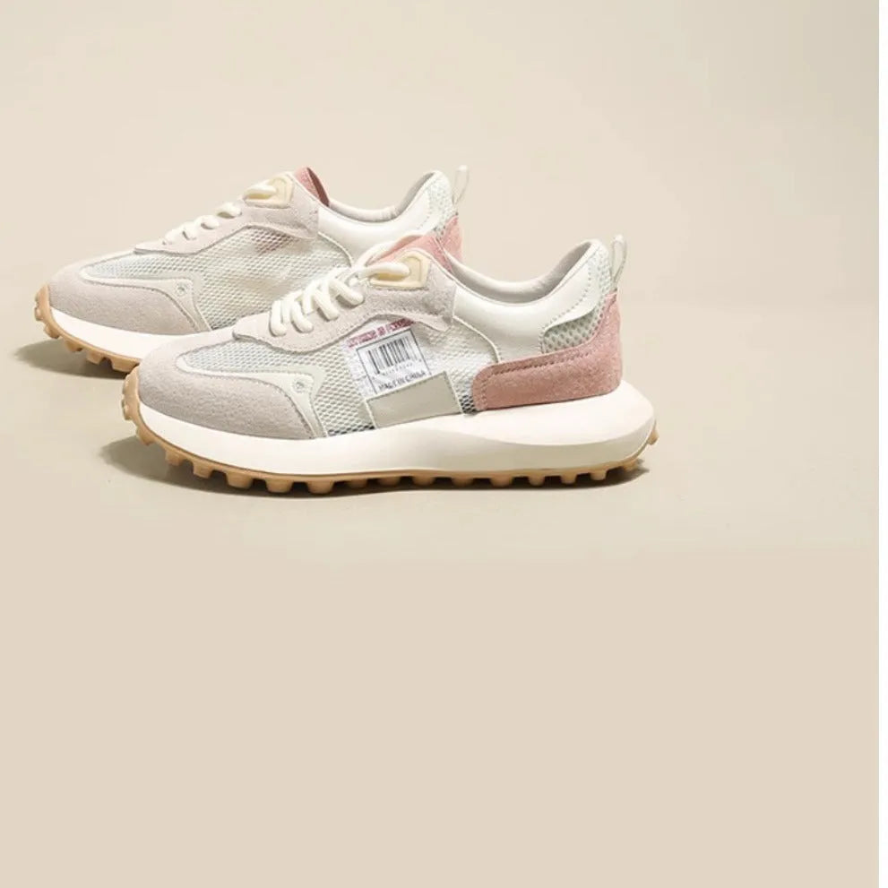 Women's pink and grey retro low-top sneaker with round toe and flat rubber sole.