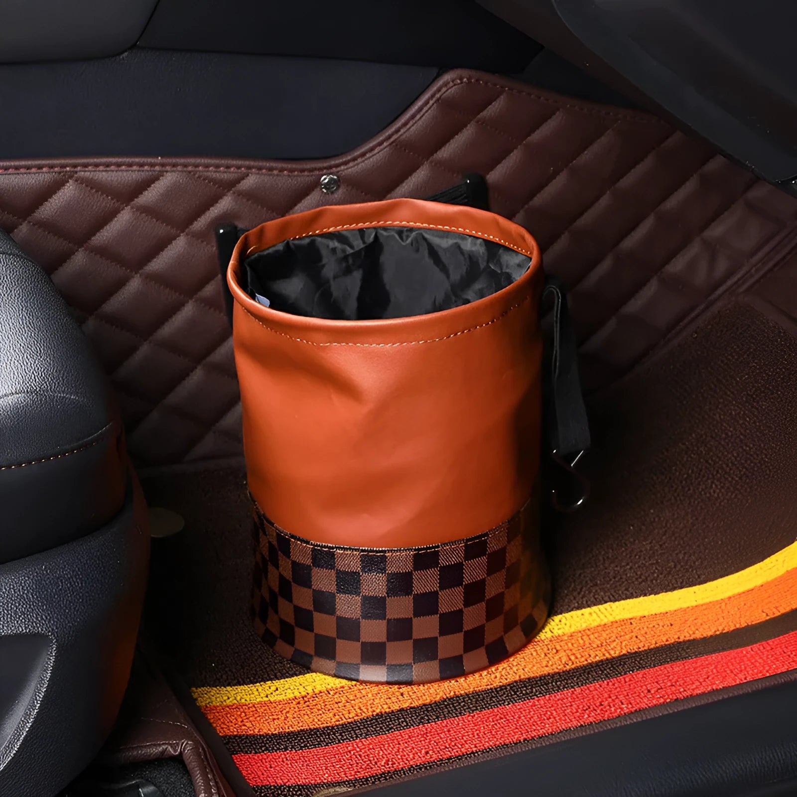 Retractable leather car trash can with waterproof lining and carry handle shown in vehicle