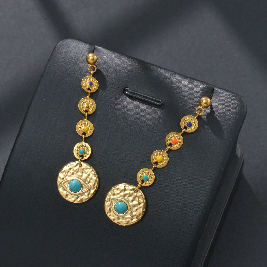 Stainless steel geometric drop earrings showing Eight Awn Star, Eye, and Shell Sun design options.
