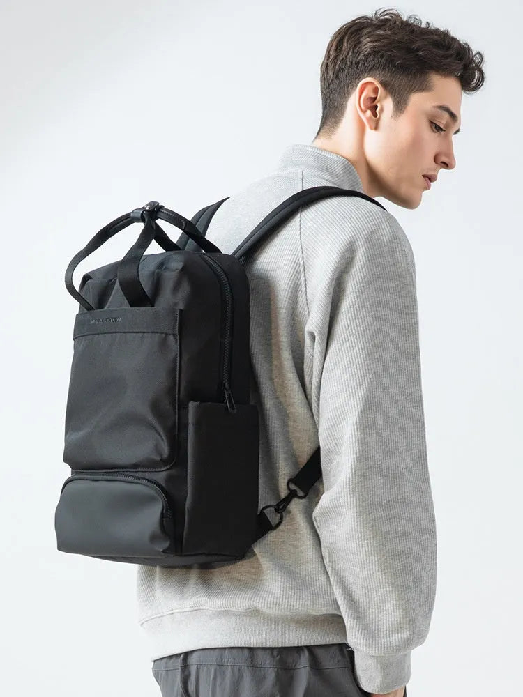 Black Oxford cloth laptop backpack showing 20-35L capacity and lightweight design.