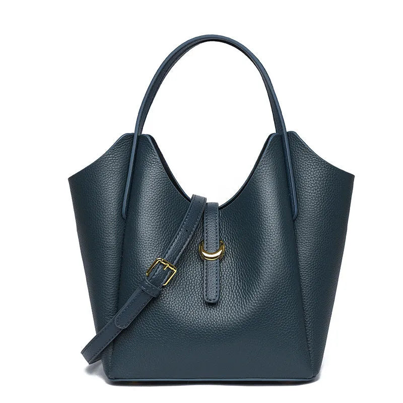 Genuine leather women's hand holding bucket bag in retro style with file compartment interior.