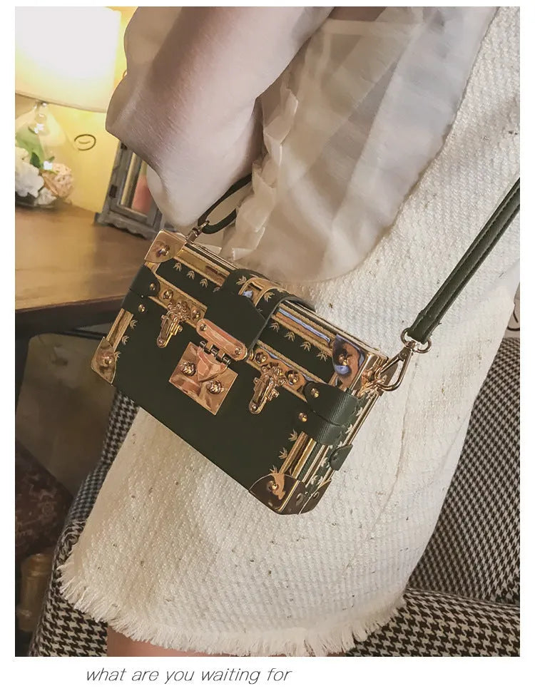 Women's black hard case shoulder bag with flap closure and single strap