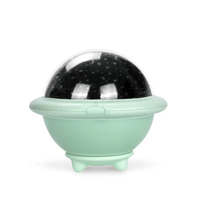 Green UFO-shaped plastic LED night light projecting starry sky pattern on a dark wall