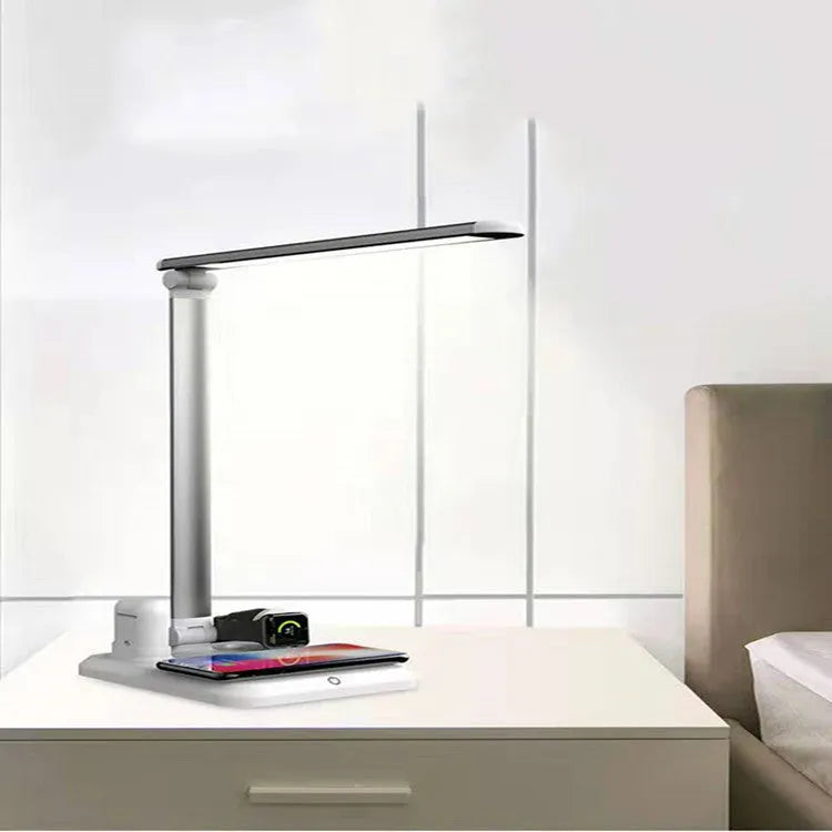 Black 4-in-1 LED desk lamp with adjustable arm and wireless charging pad for mobile phones