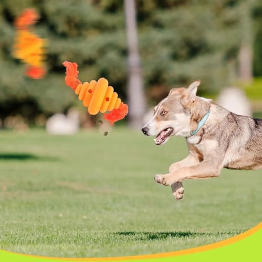 Green and yellow silicone dog ball with attached rope for tug-of-war and treat dispensing.