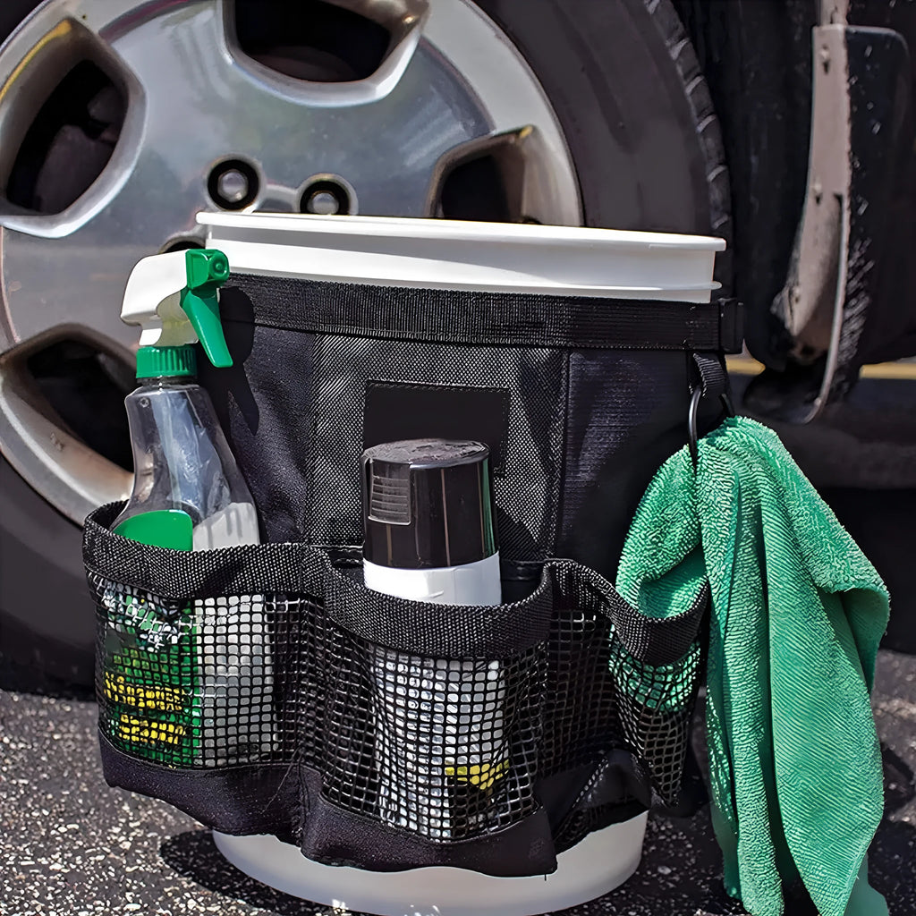 Black cylindrical polyester storage bag hanging from buggy attachment, compatible with 5 gallon barrel