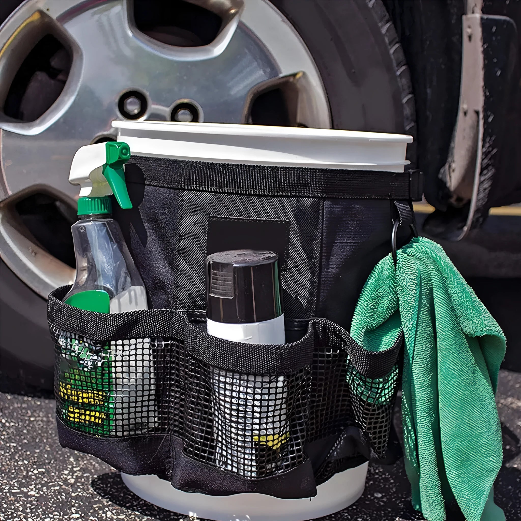 Black cylindrical polyester storage bag hanging from buggy attachment, compatible with 5 gallon barrel