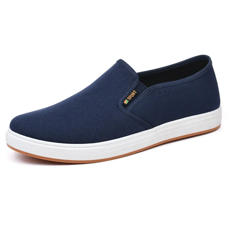 Men's black low-top canvas slip-on shoes with round toe and shallow mouth design on a white background.