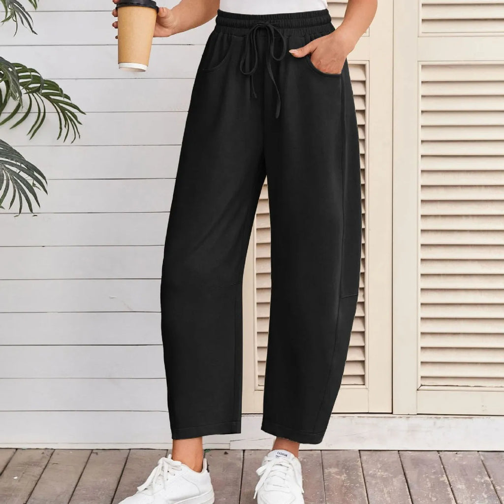 Women's loose cotton cropped sweatpants with drawstring waist in street fashion styling