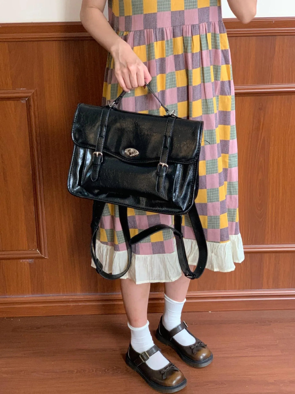 Black college style messenger bag made from oil wax leather PU material with dimensions of 35cm length