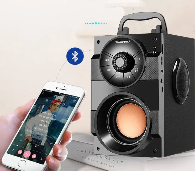 Black portable mini home audio system with subwoofer, connection cable, and charging accessories