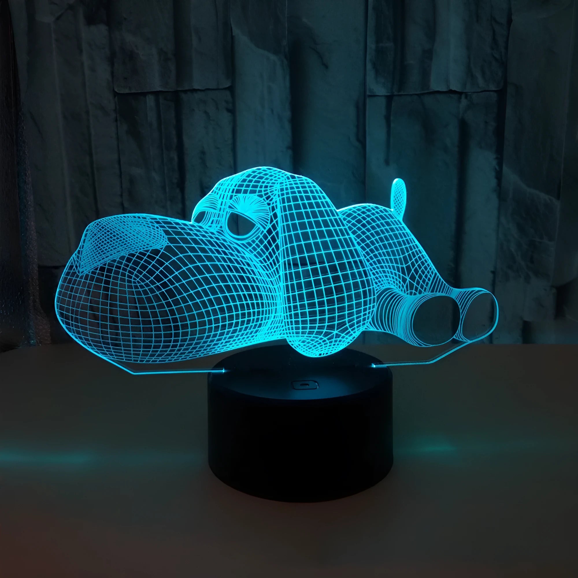 Glowing 3D illusion dog desktop night light showing multiple colour options on a desk.