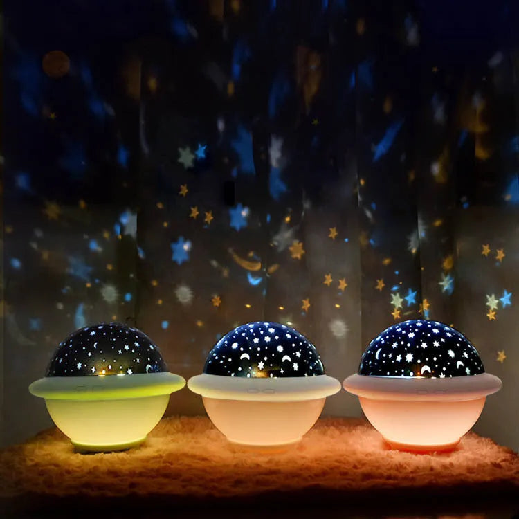 Green UFO-shaped plastic LED night light projecting starry sky pattern on a dark wall