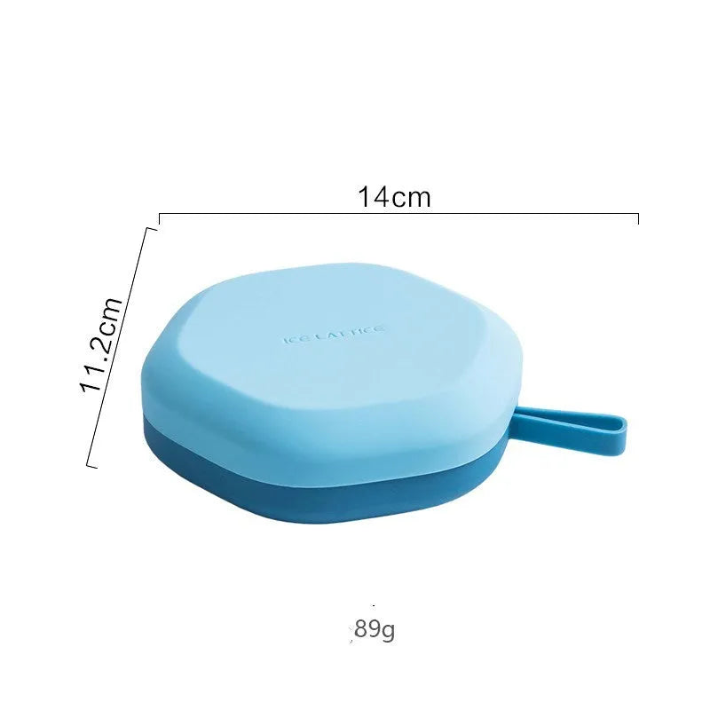 Silicone 12 cavity hexagon ice cube mold in blue with diamond shaped cavities on white background