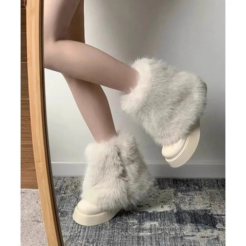 Women's black fleece-lined snow boots with a waterproof rubber platform sole on a white background.