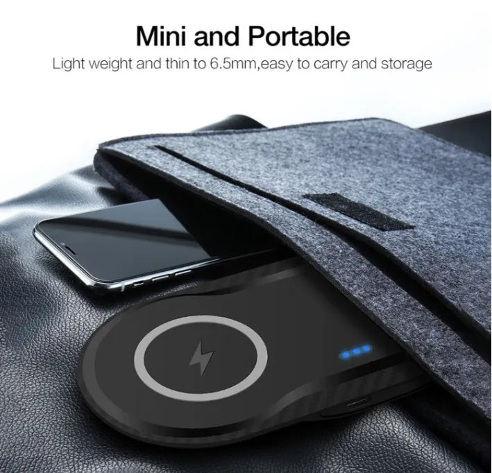 Black dual wireless charging pad charging two smartphones simultaneously on desk