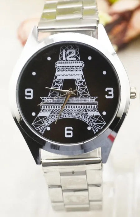 Silver Eiffel Tower wrist watch with stainless steel bracelet on a white dial.
