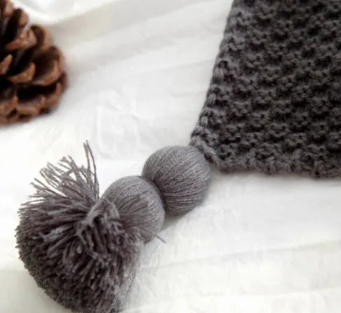 Nordic style fringed knit ball acrylic blanket in neutral colour on sofa