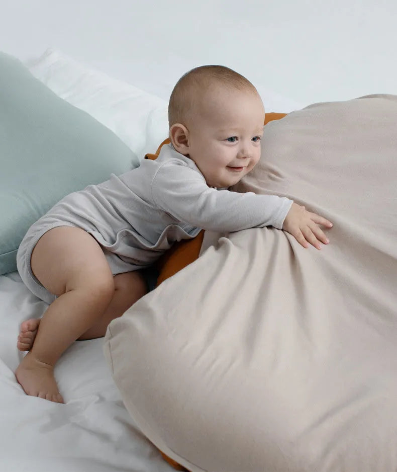 Beige portable cotton baby nest crib cushion for newborn infant sleep.