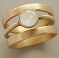 Gold geometric ring with hollow white chalcedony inlay on titanium steel band