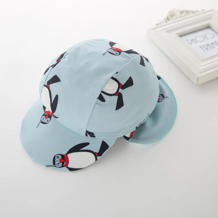 Boy's penguin themed long sleeve swimsuit with matching swimming cap for sun protection