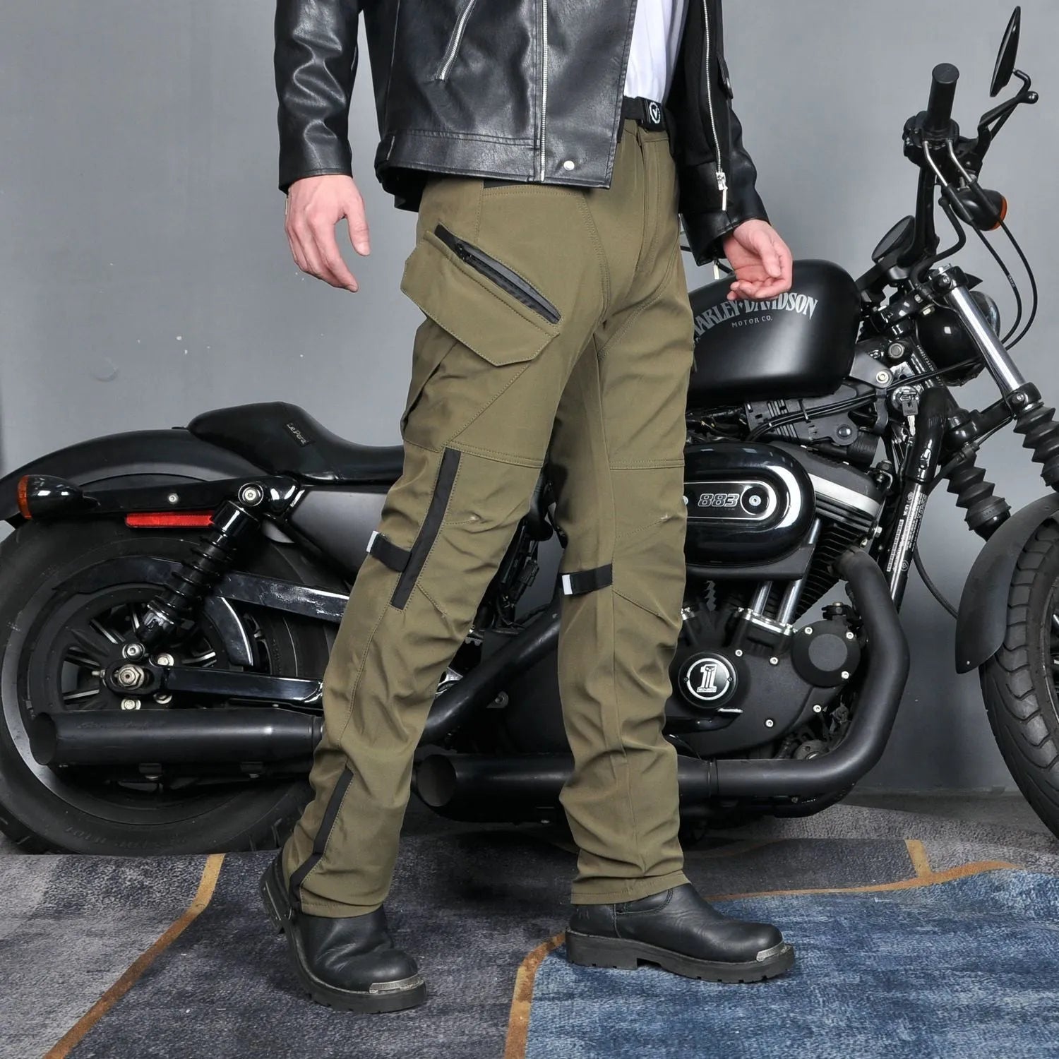 Men's waterproof motorcycle trousers in green and black colours with belt and protective gear