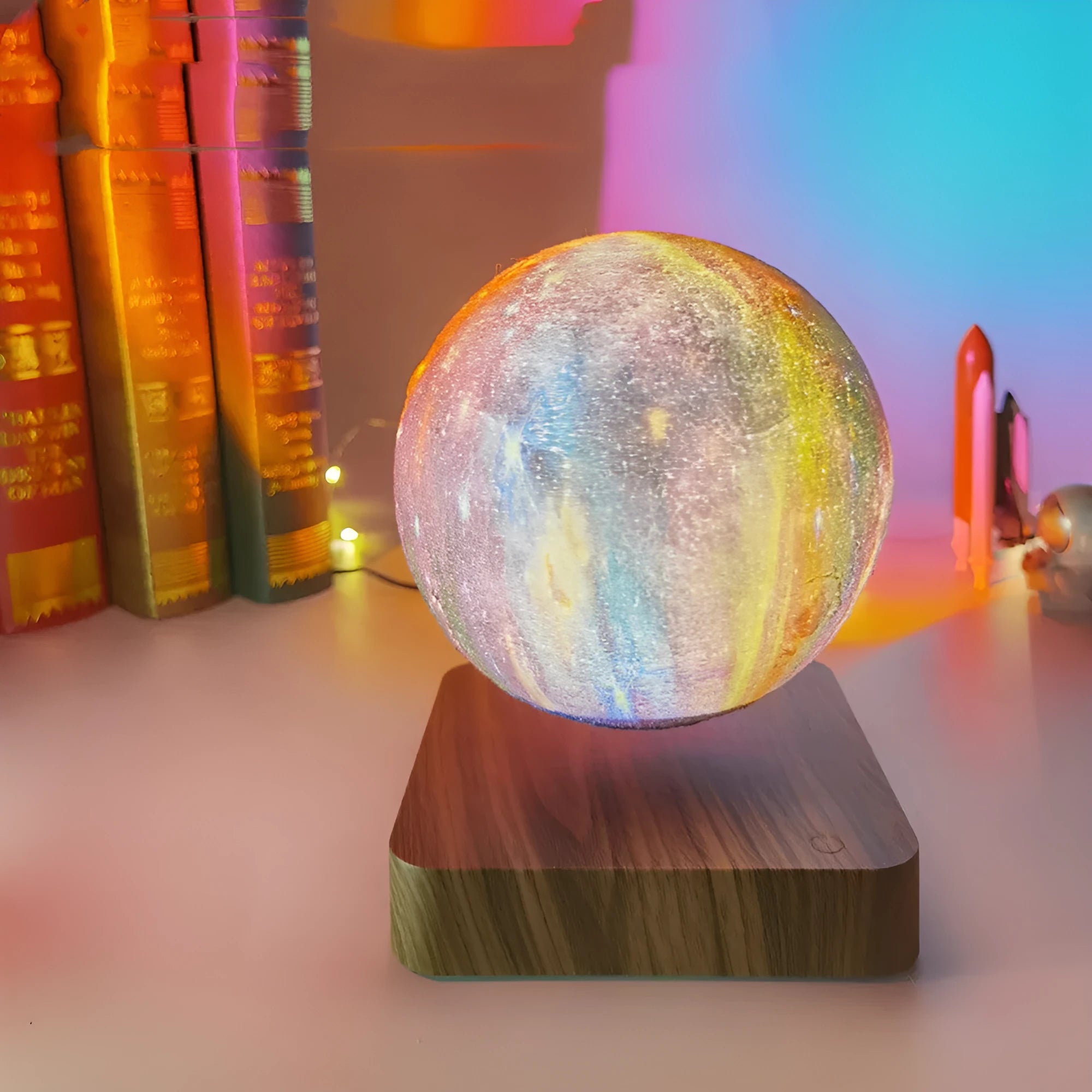Magnetic levitation galaxy decorative light with rotating moon lamp above walnut-coloured circular base