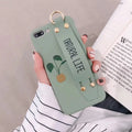 Green graffiti design phone case with a detachable silicone wristband, shown fitted on an iPhone.