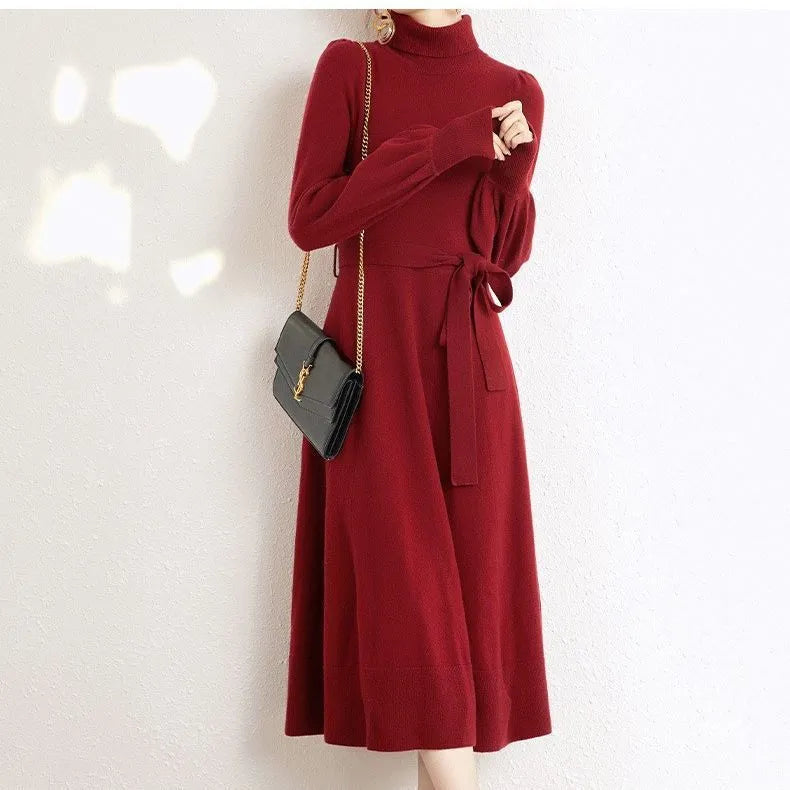 Loose-fit turtleneck knit dress for women with long sleeves, elastic waist, and a flowing mid-length princess skirt.