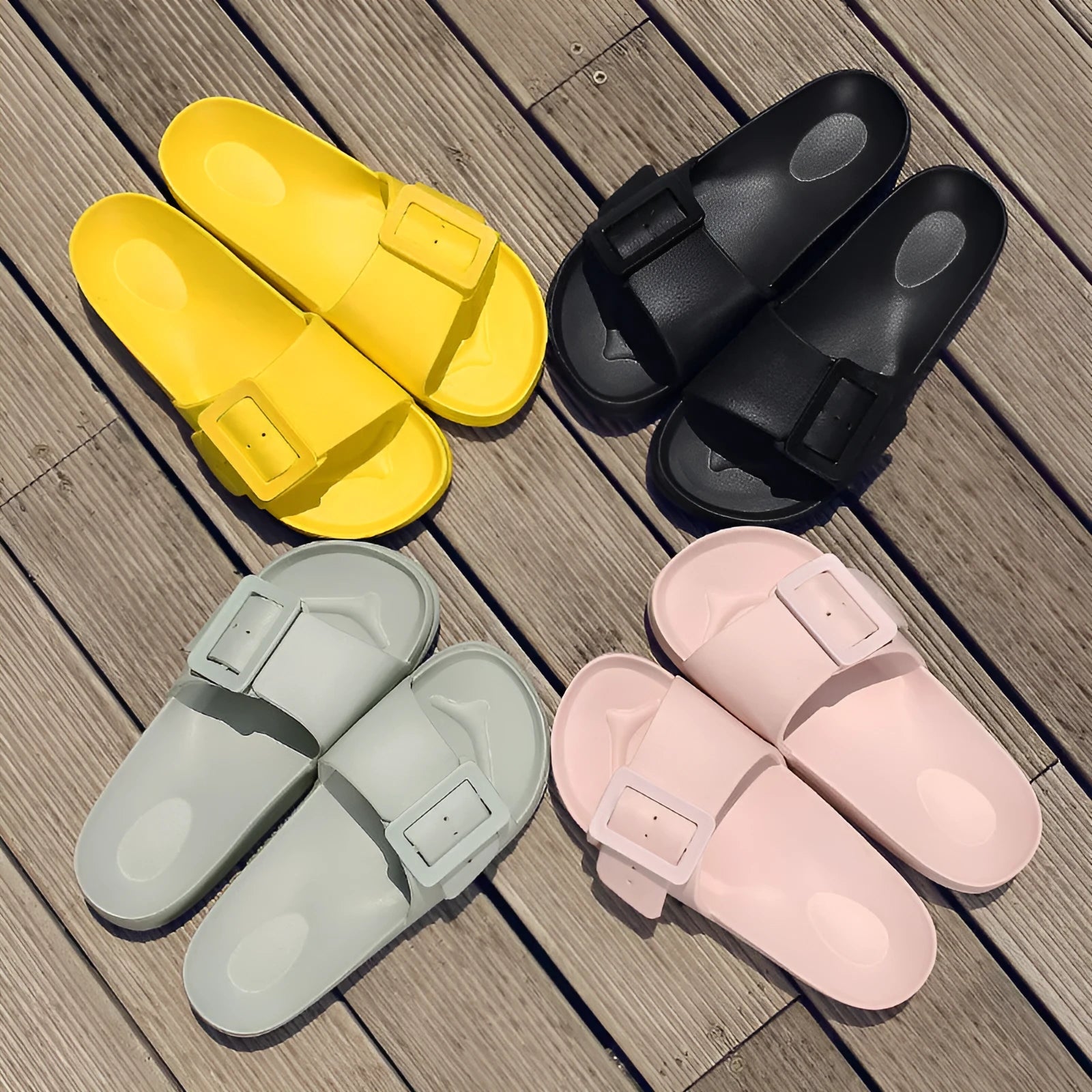 Women's grey blue EVA buckle slippers on a light background.