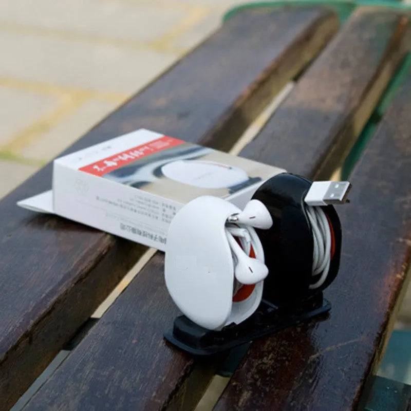 Automatic earphone cable winder retractor in a compact plastic case.