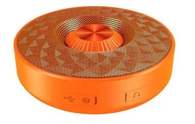 Compact black portable Bluetooth speaker on a table, showing its small size and design.