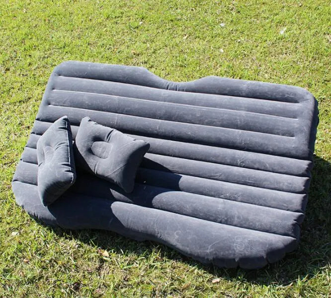 Black inflatable car bed with flocked surface, two pillows, and storage bag for five-seater vehicles