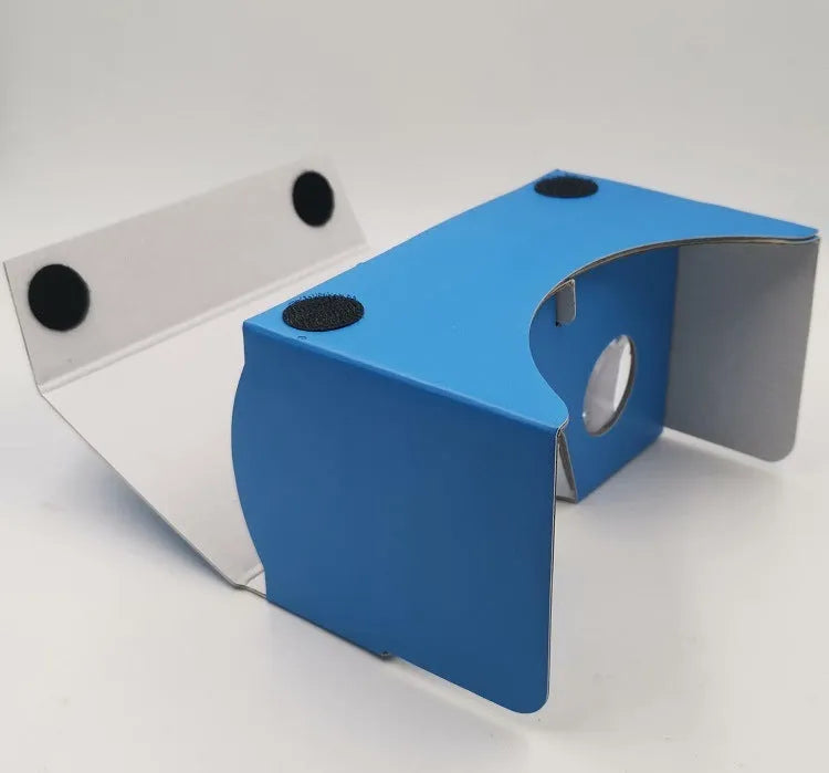Pink and white foldable VR Cardboard viewer headset for 6-inch smartphones with head strap.