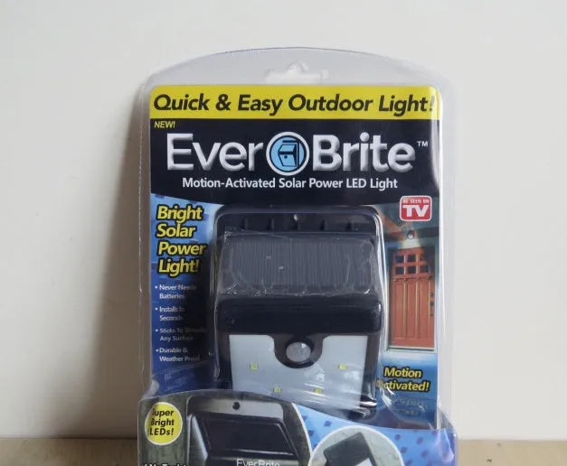 Set of four black solar-powered LED motion sensor lights for outdoor garden and pathway lighting