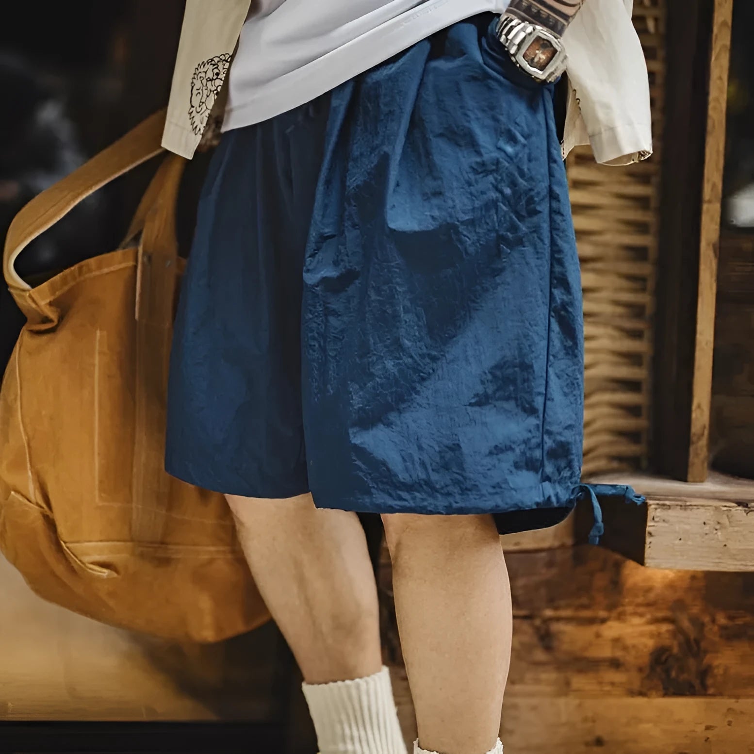 Men's loose Prussian Blue nylon summer shorts showing fifth pants length and non-elastic waistband.