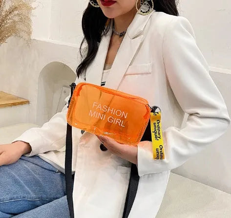 A transparent square jelly crossbody bag with a single adjustable shoulder strap.