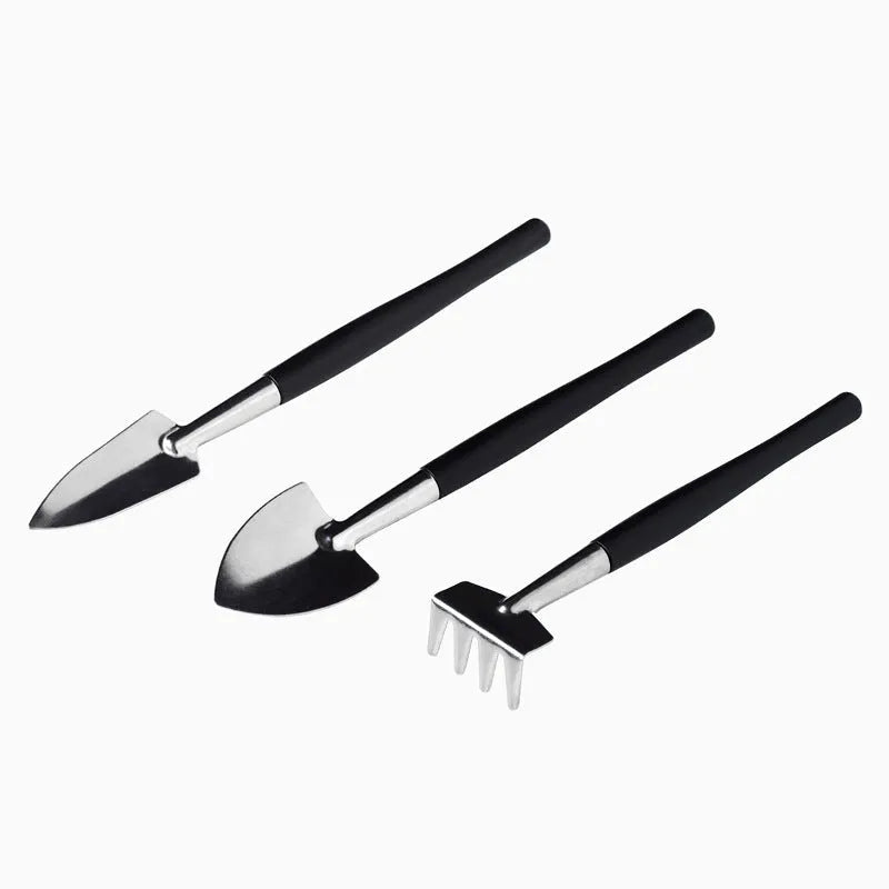Black mini garden tool set for succulents with 15 tools including shovel, tweezers, watering bottle, and a square cushion.