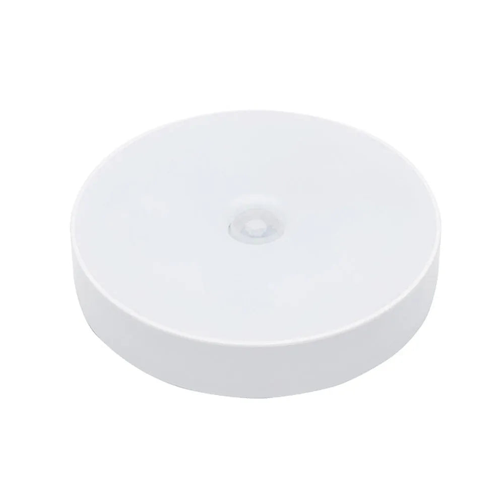 White motion sensor LED night light with USB charging port and adhesive backing