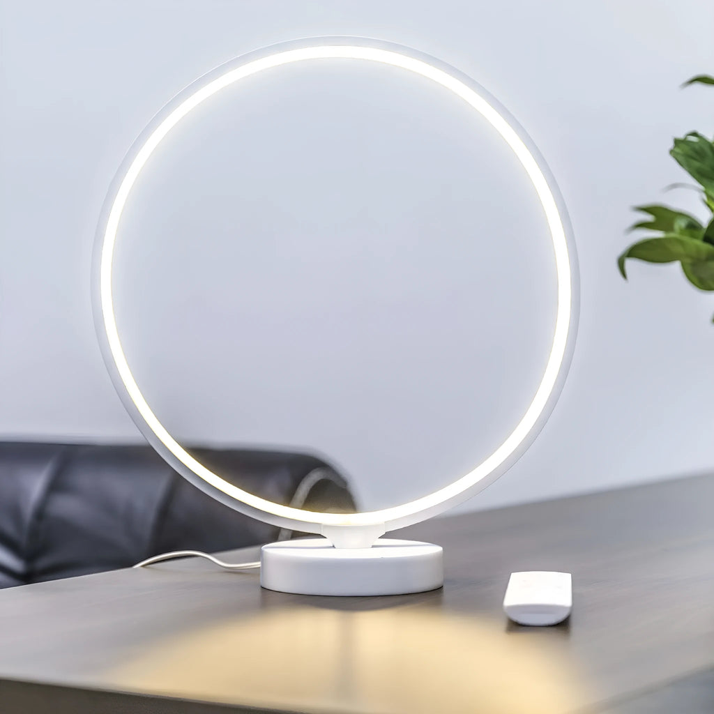 White Full Moon mood lamp on a table with remote control, showing soft ambient glow.