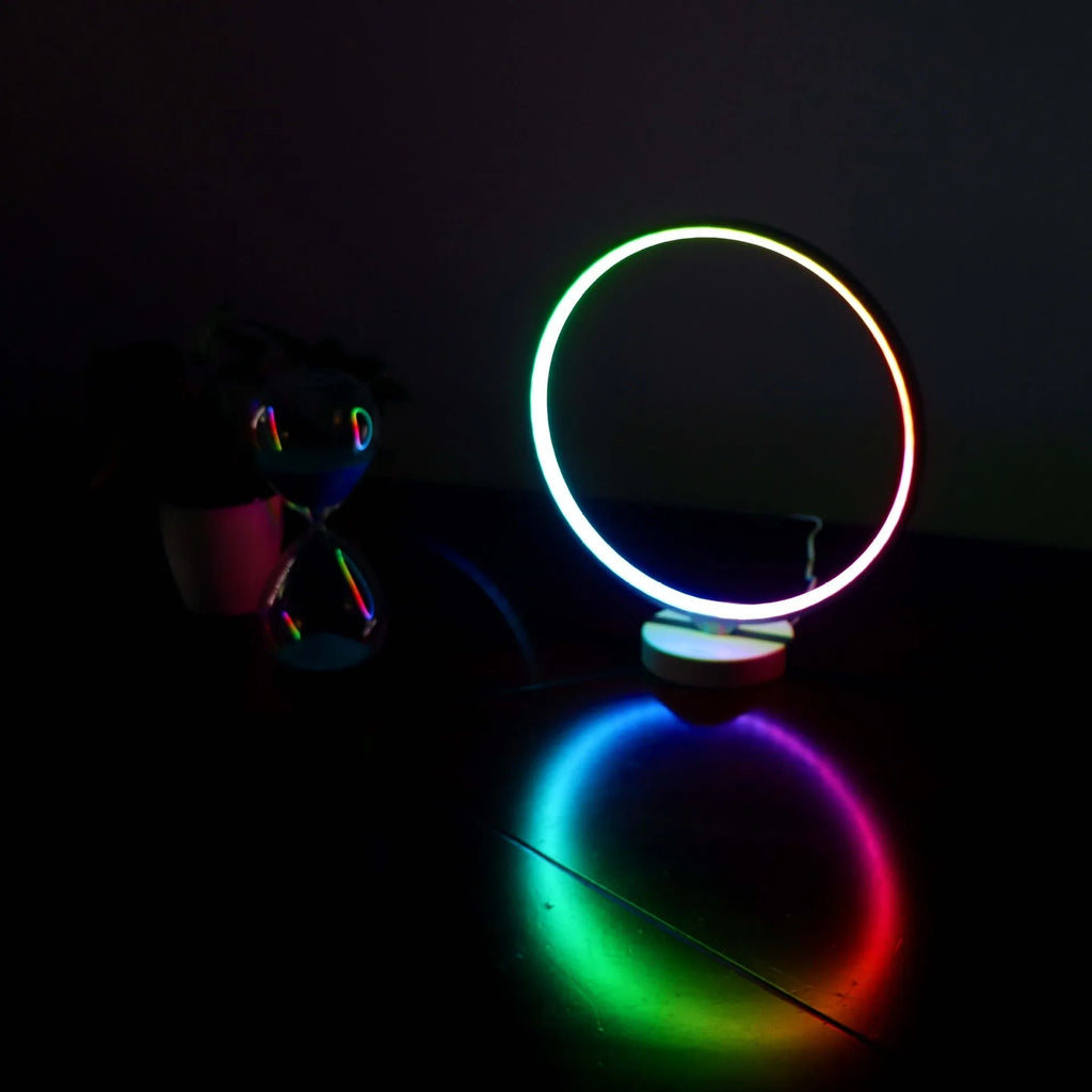 White Full Moon mood lamp on a table with remote control, showing soft ambient glow.
