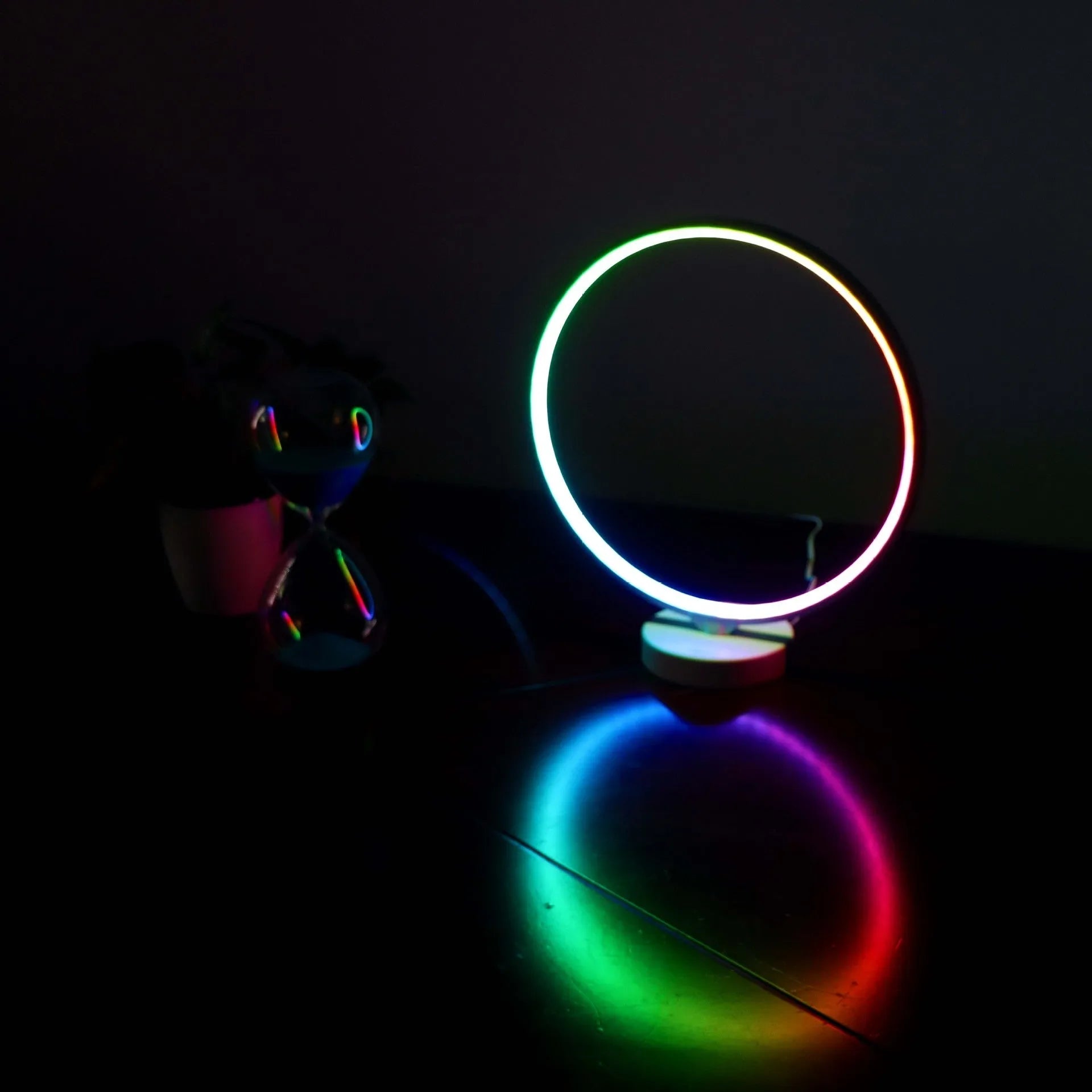 White Full Moon mood lamp on a table with remote control, showing soft ambient glow.