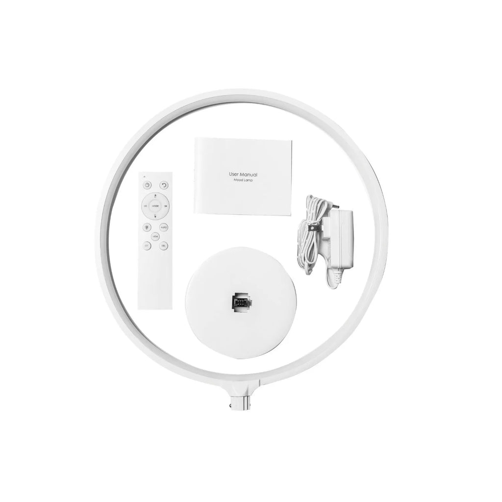 White Full Moon mood lamp on a table with remote control, showing soft ambient glow.