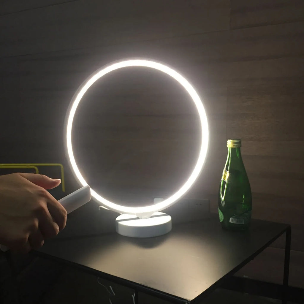 White Full Moon mood lamp on a table with remote control, showing soft ambient glow.
